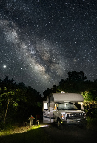 RV in campground under the milky way