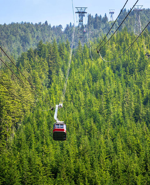 Overhead Cable Car Taking Tourists to the Top of Grouse Mountain, Vancouver, Canada, on a Sunny Summer Day
